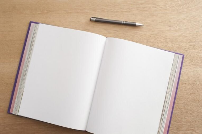 An open blank notebook and pen, ready for writing